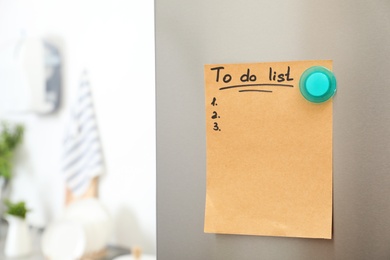 Photo of To do list with magnet on refrigerator door indoors. Space for text