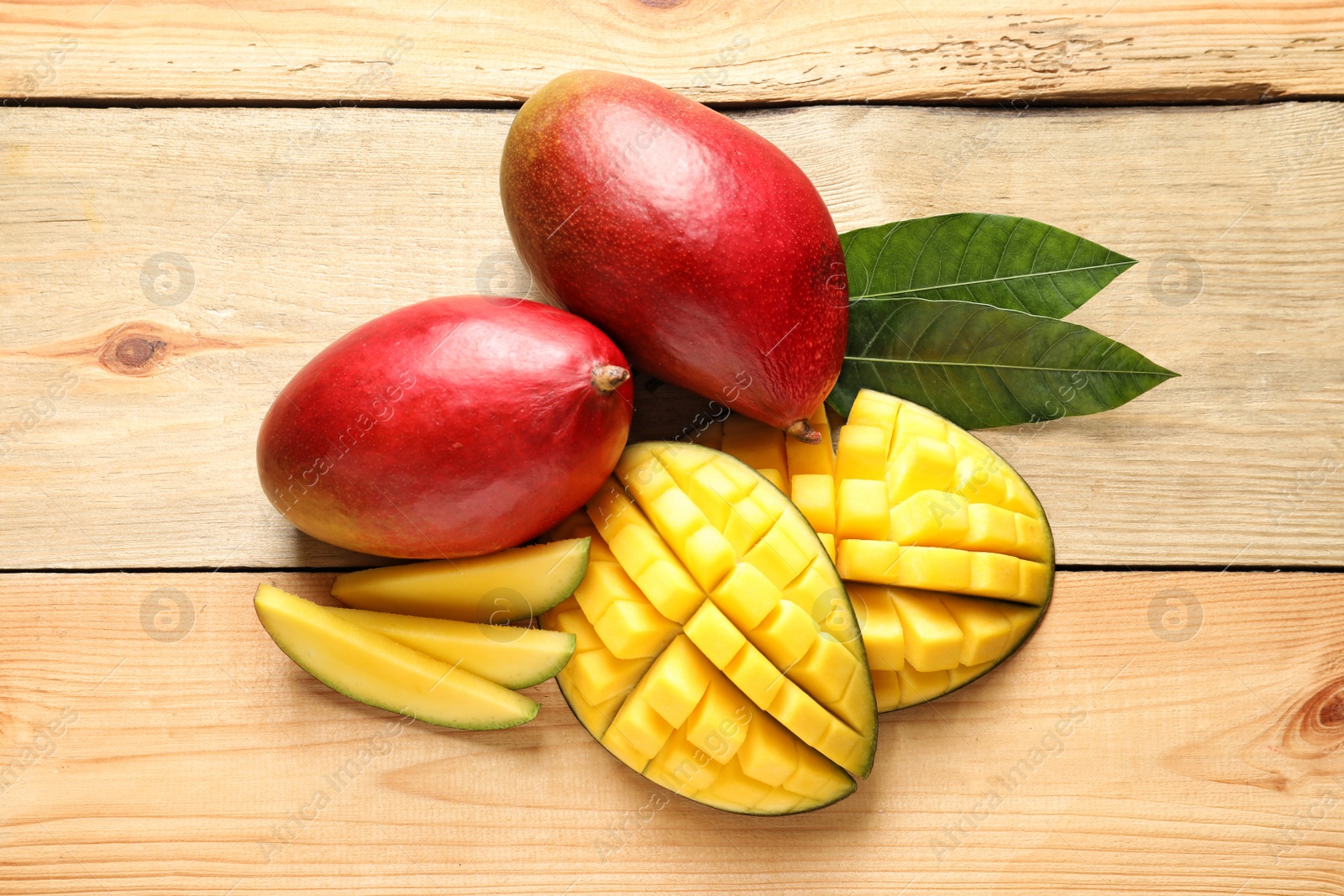 Photo of Composition with mango on light wooden background