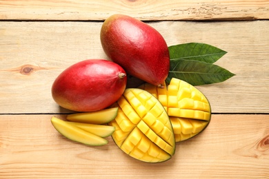 Photo of Composition with mango on light wooden background