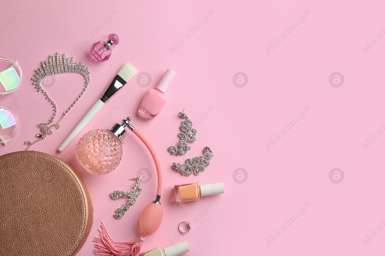 Photo of Composition with perfume bottles, cosmetics and jewellery on color background, flat lay. Space for text