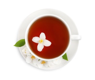 Photo of Cup of aromatic jasmine tea and fresh flowers on white background, top view