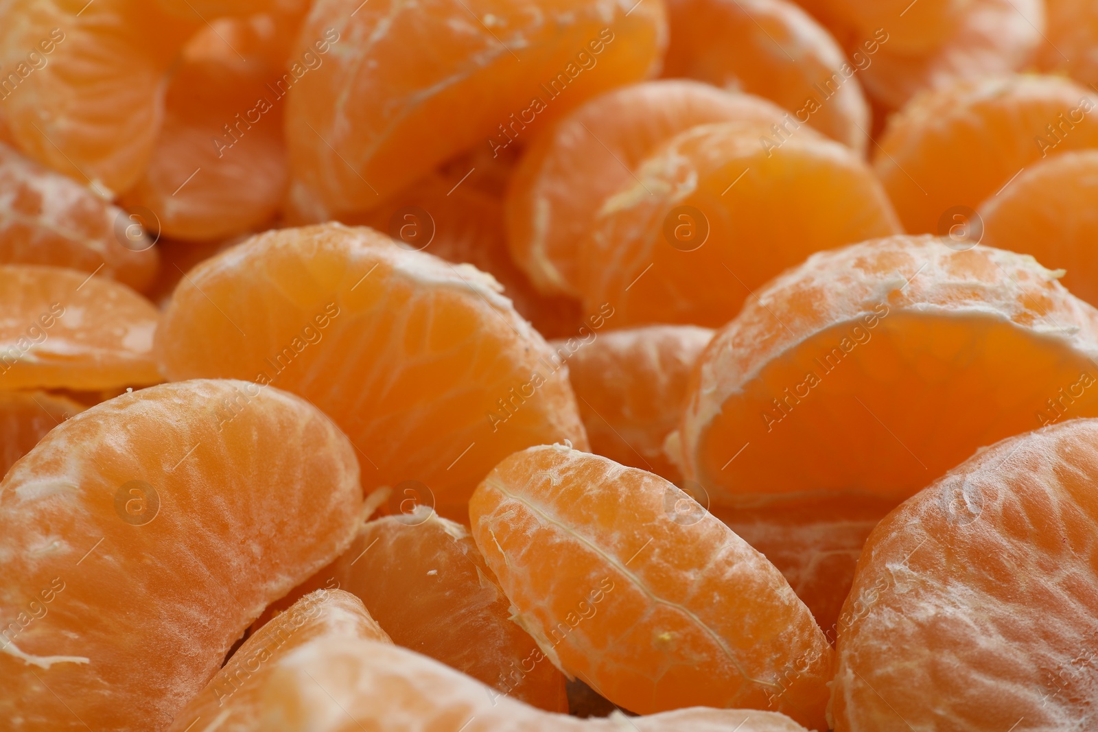 Photo of Delicious tangerine segments as background, closeup view