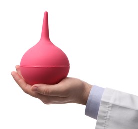 Photo of Doctor holding pink enema on white background, closeup