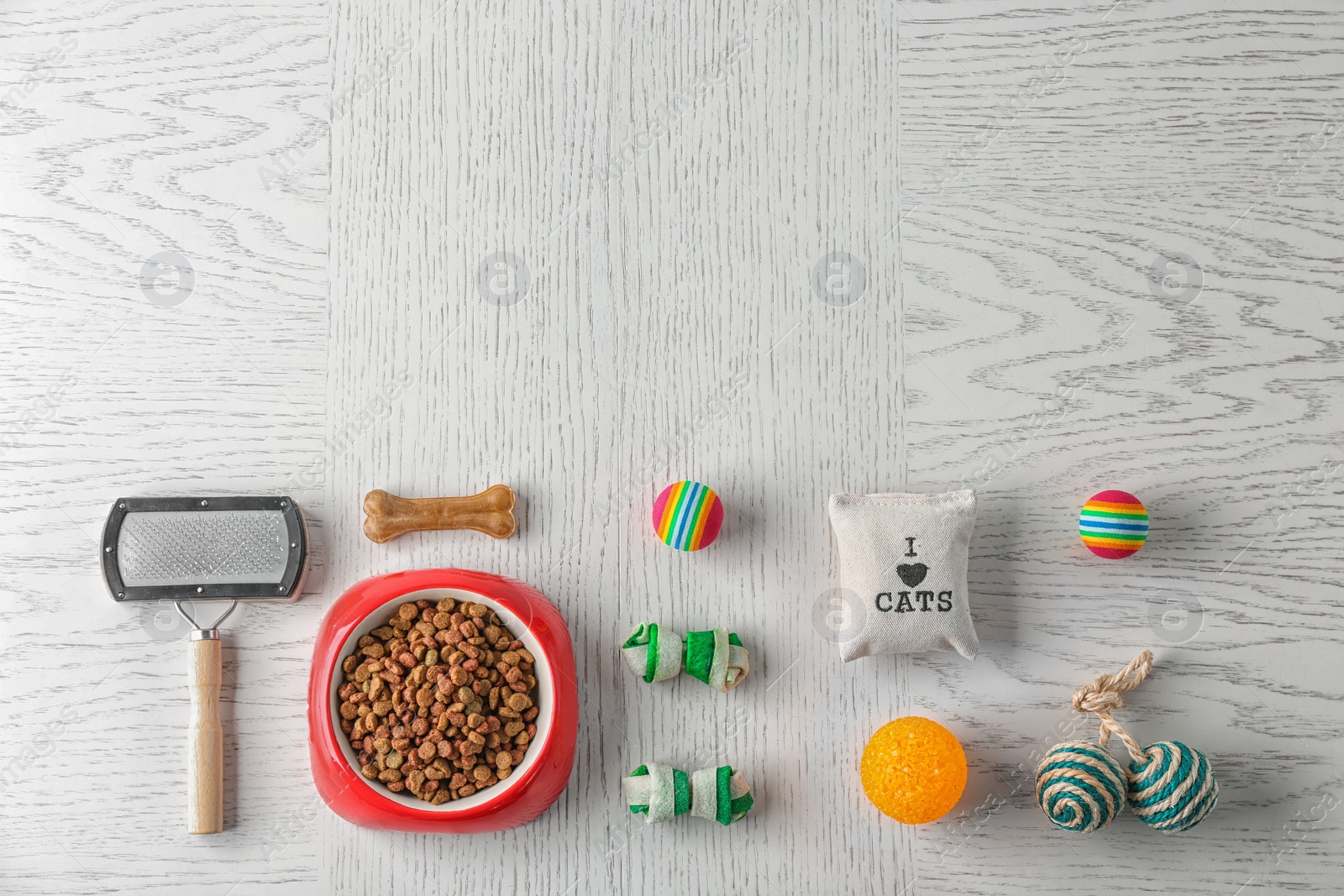 Photo of Flat lay composition with cat accessories and food on wooden background