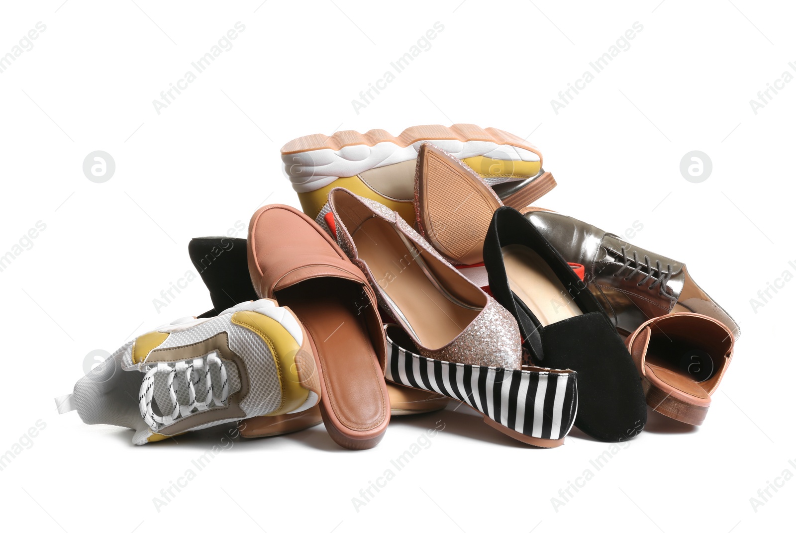 Photo of Pile of different shoes on white background