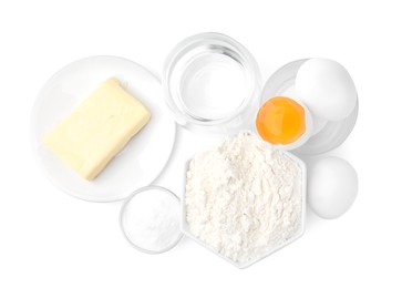 Photo of Eggs, butter, flour, salt and water isolated on white, top view. Ingredients for puff pastry dough