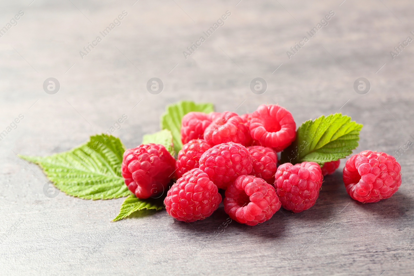 Photo of Ripe aromatic raspberries on table, closeup