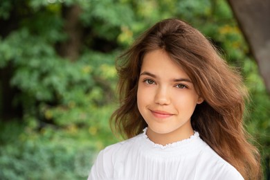 Photo of Portrait of teenage girl outdoors on sunny day, space for text