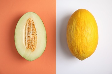 Photo of Flat lay composition with whole and cut melons on color background