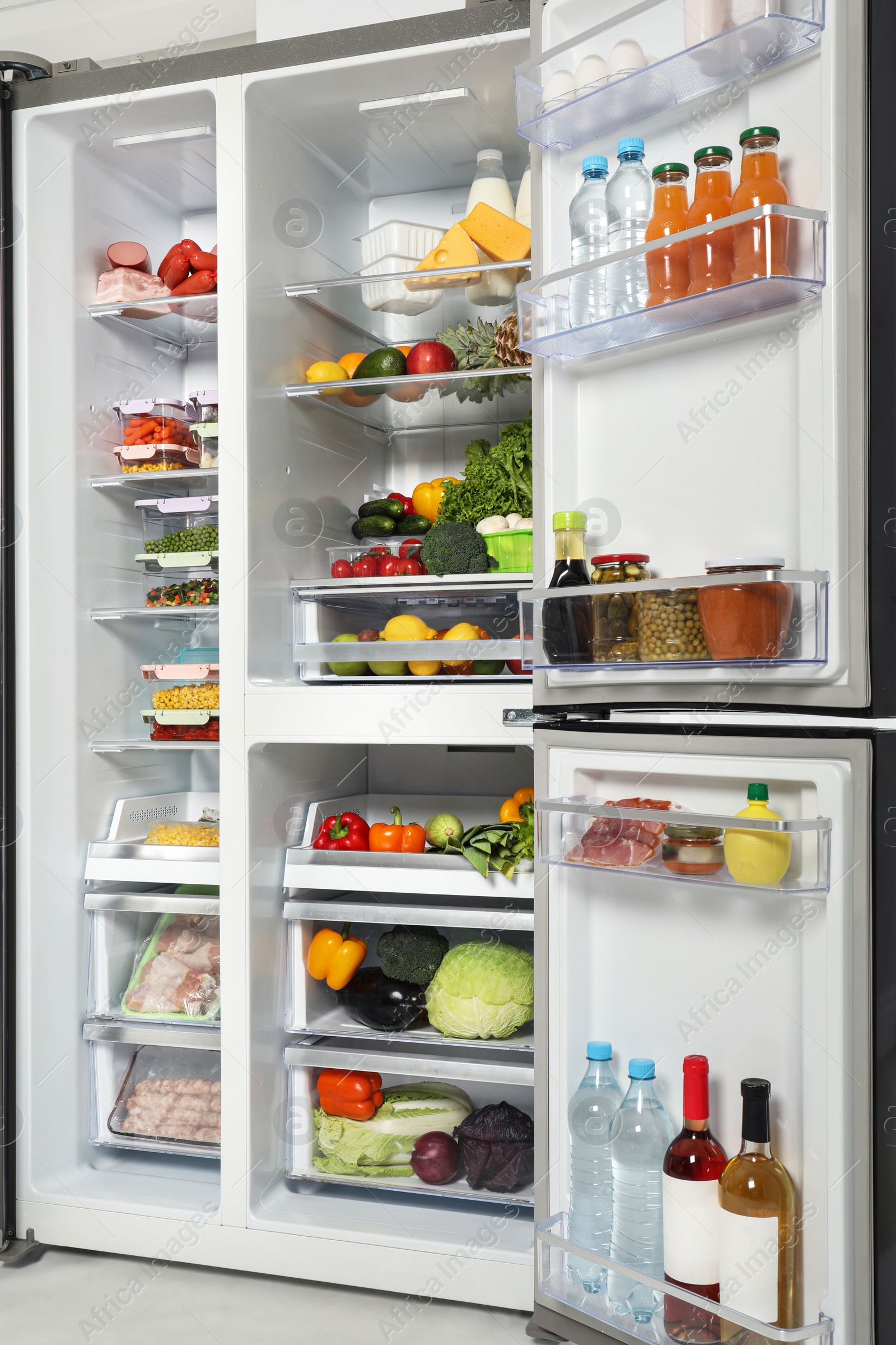 Photo of Open refrigerator full of different fresh products