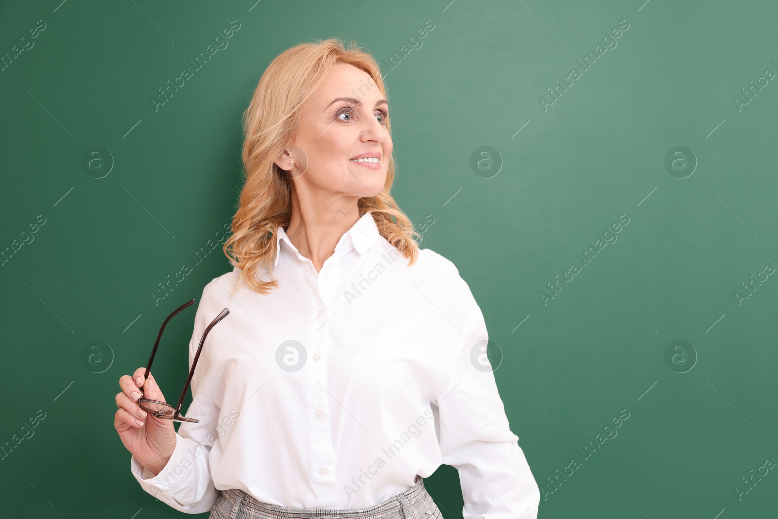 Photo of Happy professor with glasses near green board, space for text