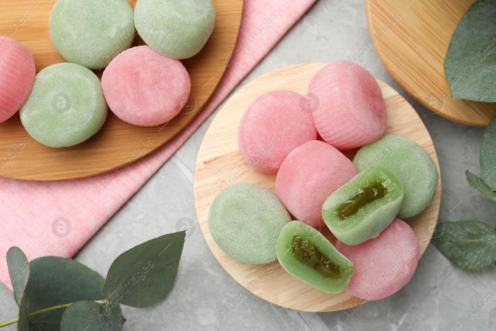 Photo of Many different delicious mochi on grey table, flat lay. Traditional Japanese dessert