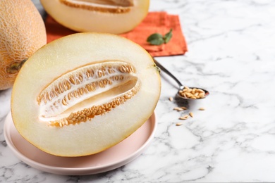 Photo of Delicious honey melon on white marble table