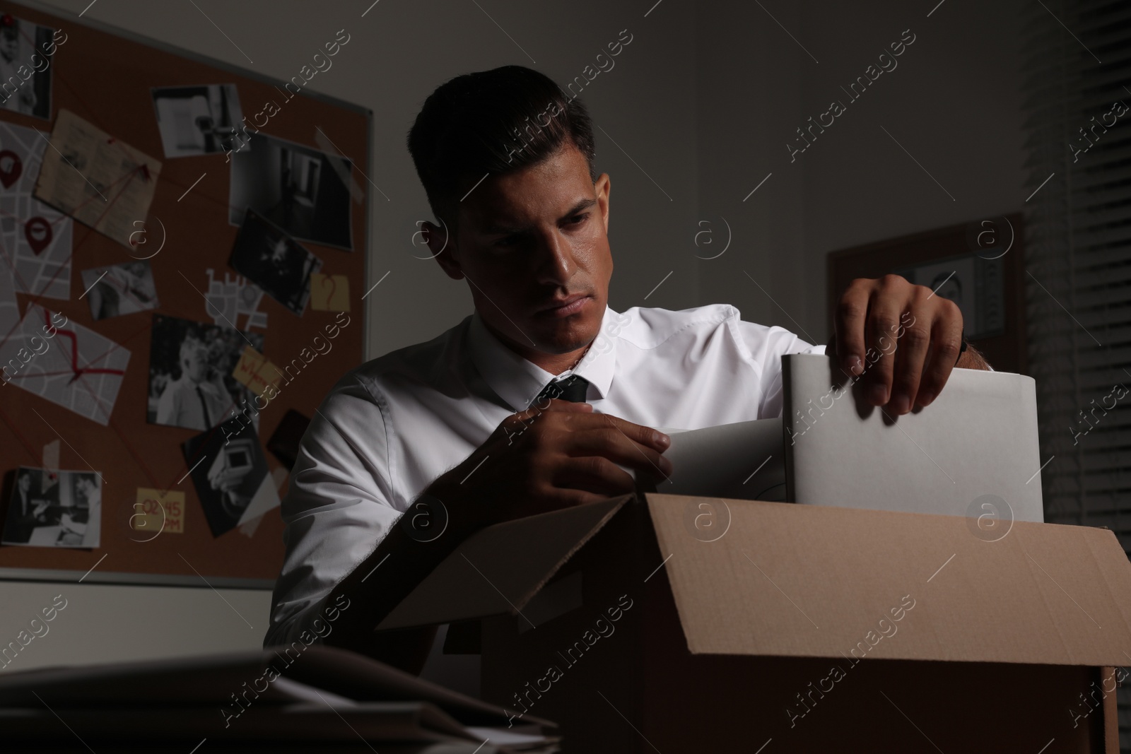 Photo of Professional detective doing paperwork in his office