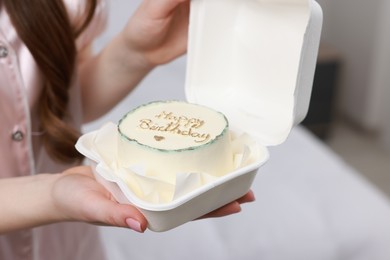 Photo of Woman holding her Birthday cake indoors, closeup