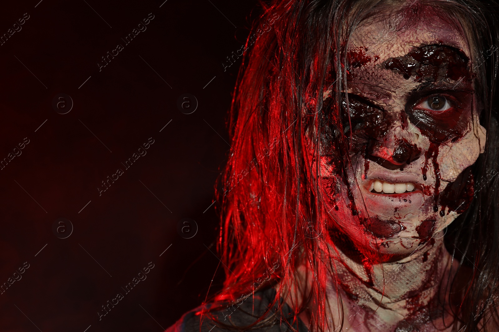 Photo of Scary zombie on dark background, space for text. Halloween monster