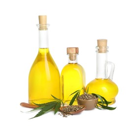 Photo of Hemp oil, fresh leaves and seeds on white background