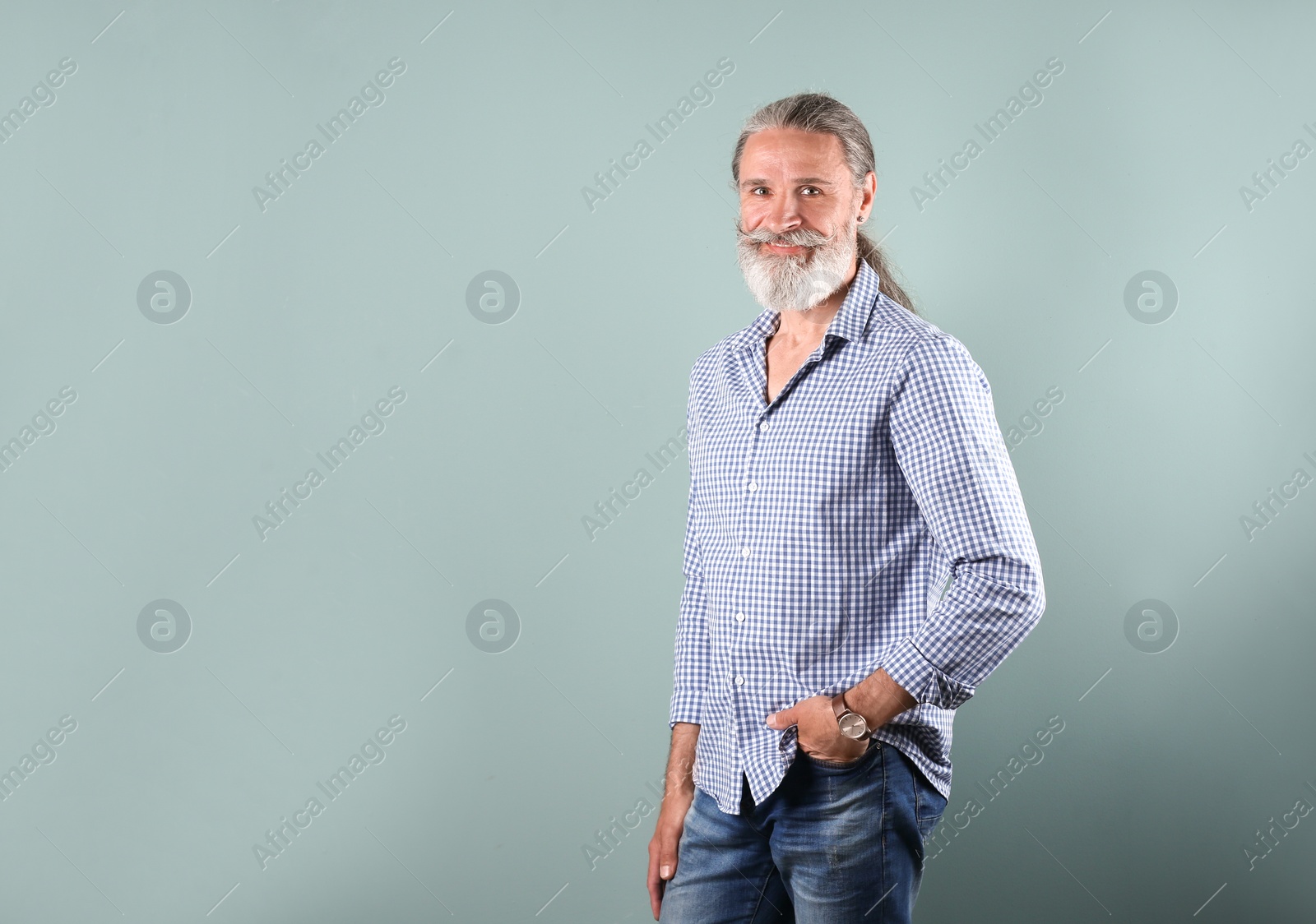 Photo of Portrait of handsome mature man on color background