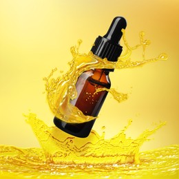 Image of Bottle of cosmetic product with essential oil and splashes around on gold gradient background