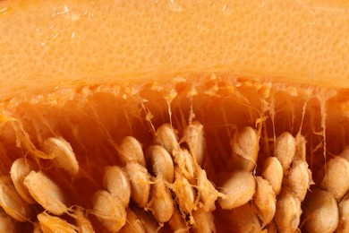 Photo of Cut fresh ripe pumpkin with seeds as background, closeup