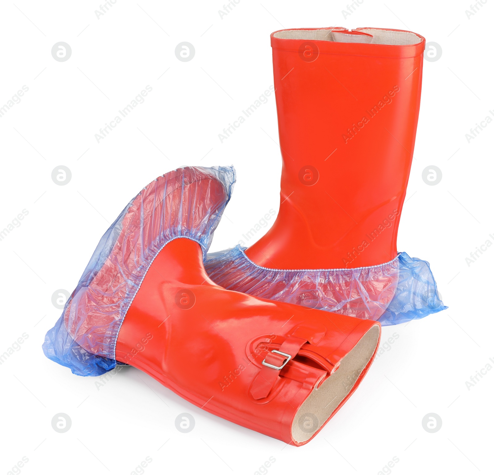 Photo of Rubber boots in blue shoe covers isolated on white