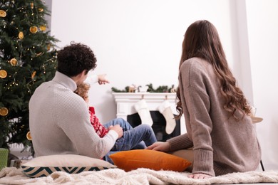 Family watching movie via video projector at home, back view