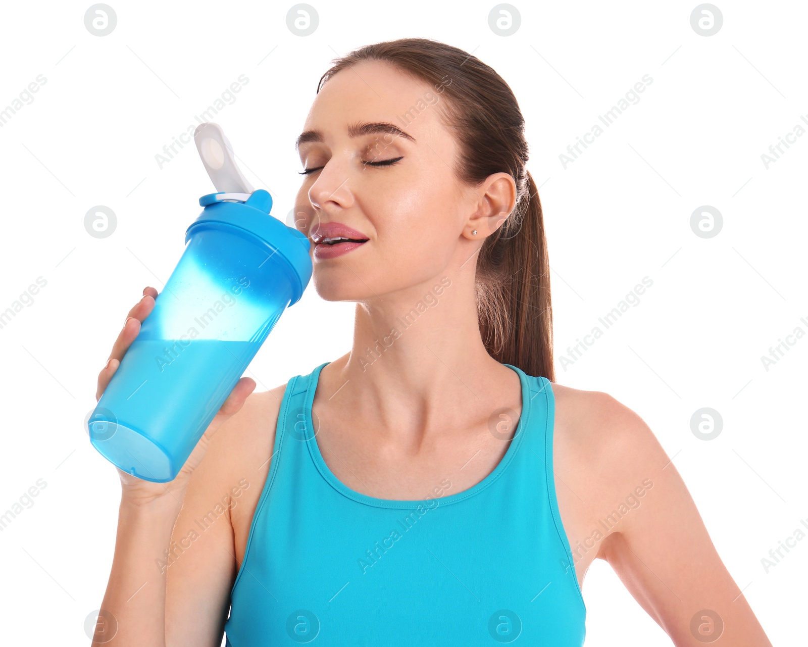 Photo of Athletic young woman drinking protein shake on white background