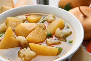 Photo of Bowl of delicious turnip soup, closeup view