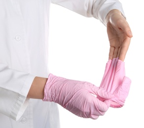 Doctor taking off medical gloves on white background