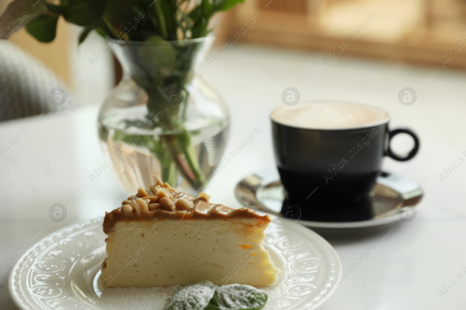 Photo of Tasty dessert and cup of fresh coffee on table indoors