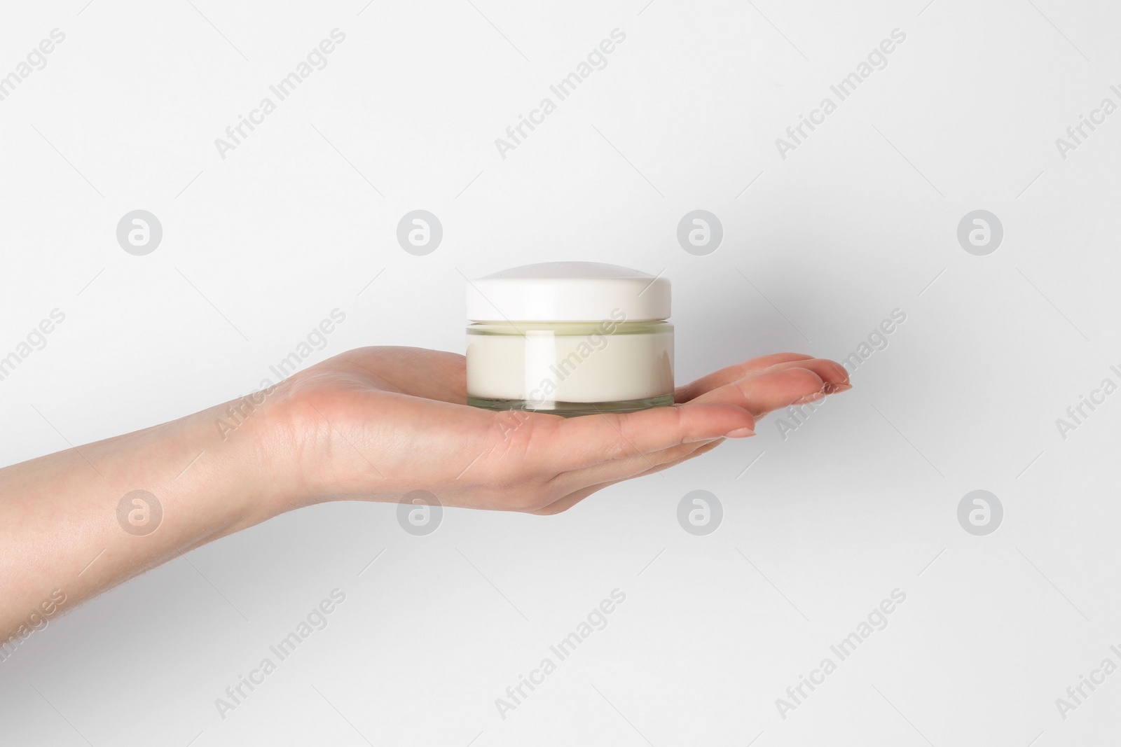 Photo of Woman with jar of cream on white background, closeup