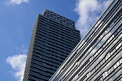 Photo of Exterior of beautiful buildings against blue sky, low angle view