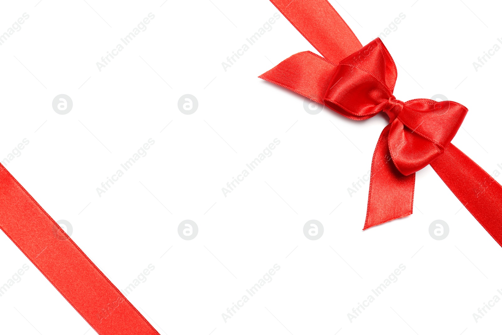 Photo of Red ribbons with bow on white background, top view