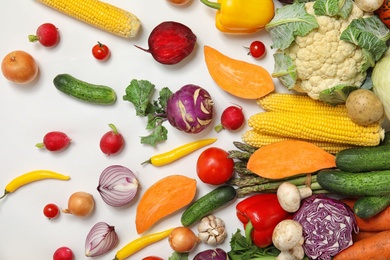 Flat lay composition with fresh vegetables on white background