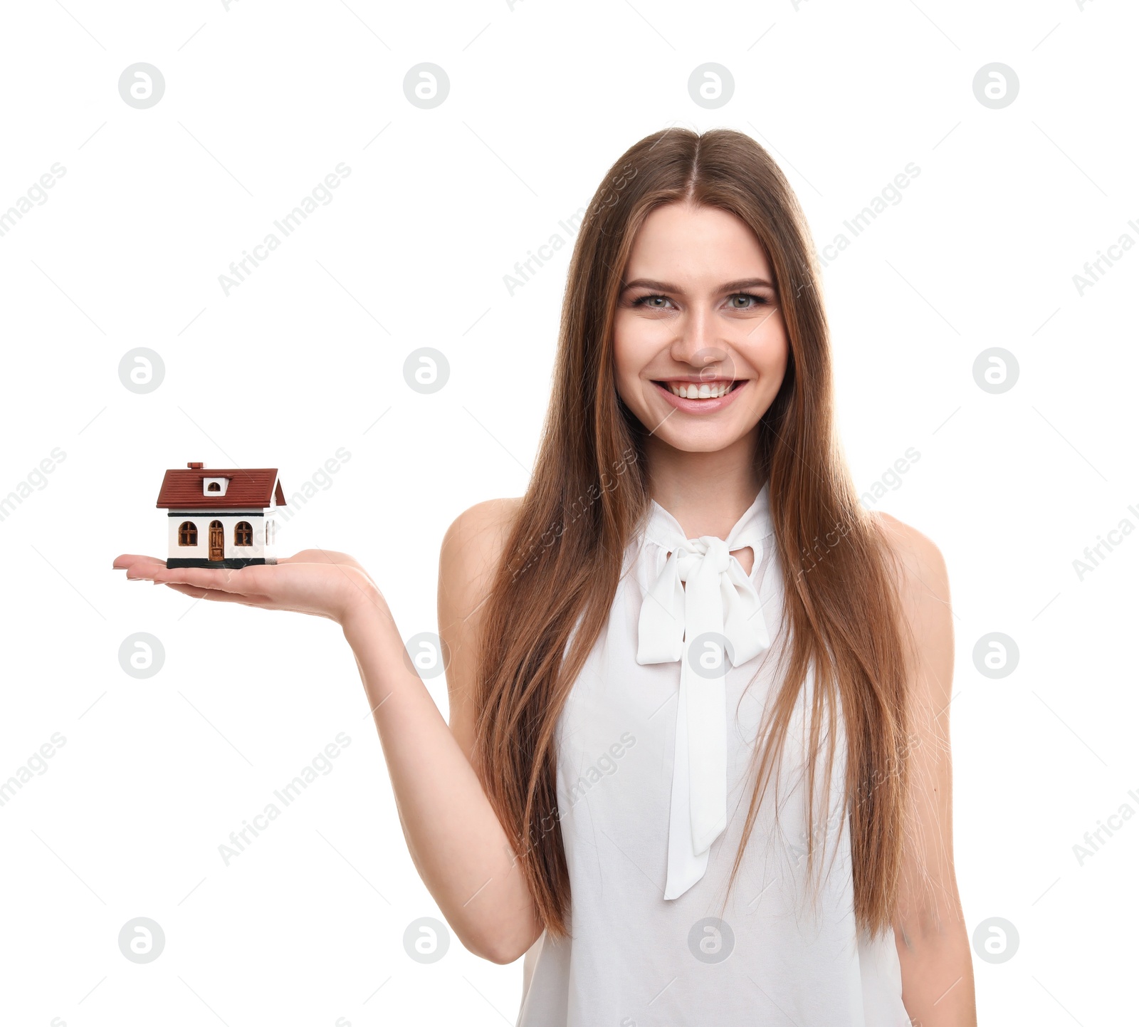 Photo of Beautiful real estate agent with house model on white background