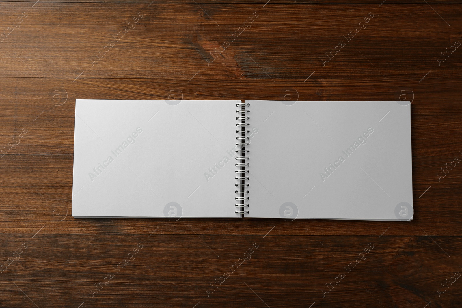 Photo of Blank paper brochure on wooden table, top view. Mockup for design