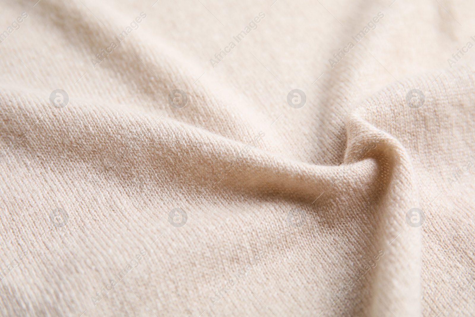 Photo of Warm cashmere sweater as background, closeup view