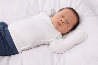 Photo of Cute newborn baby sleeping on white bed