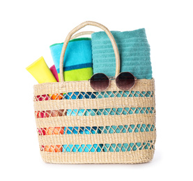 Bag with beach accessories on white background