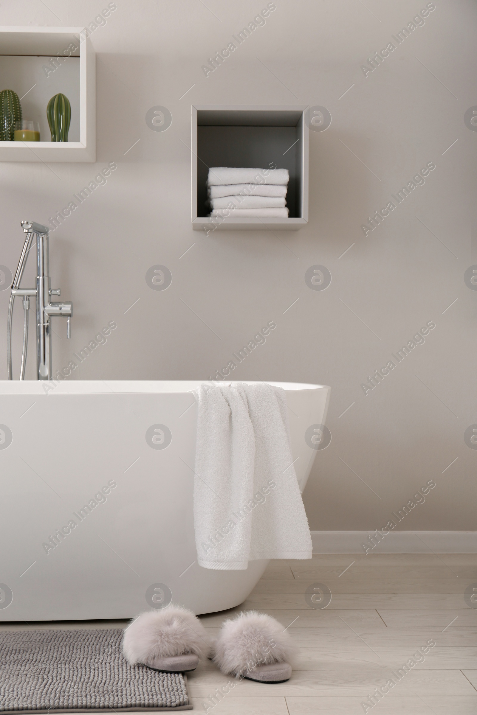 Photo of Stylish bathroom interior with modern white tub