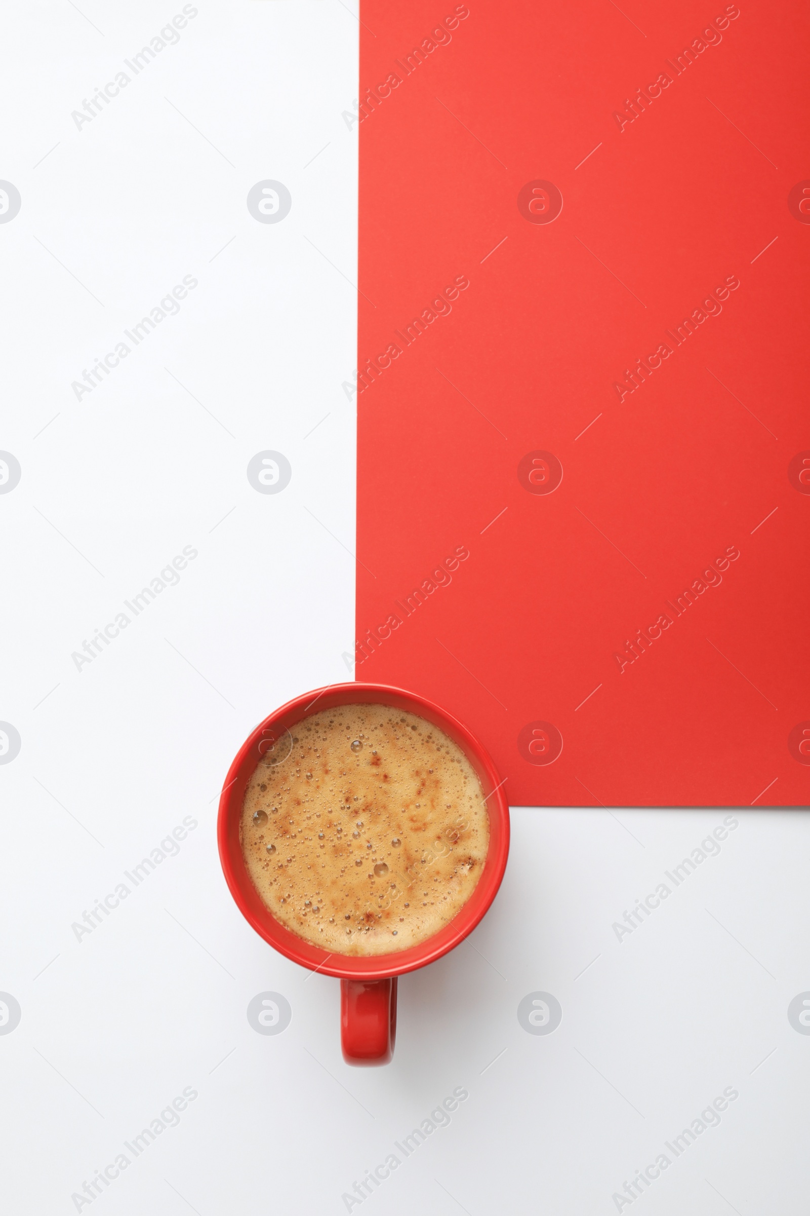 Photo of Cup of coffee on color background, top view. Space for text