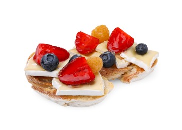 Photo of Tasty sandwiches with brie cheese and fresh berries isolated on white