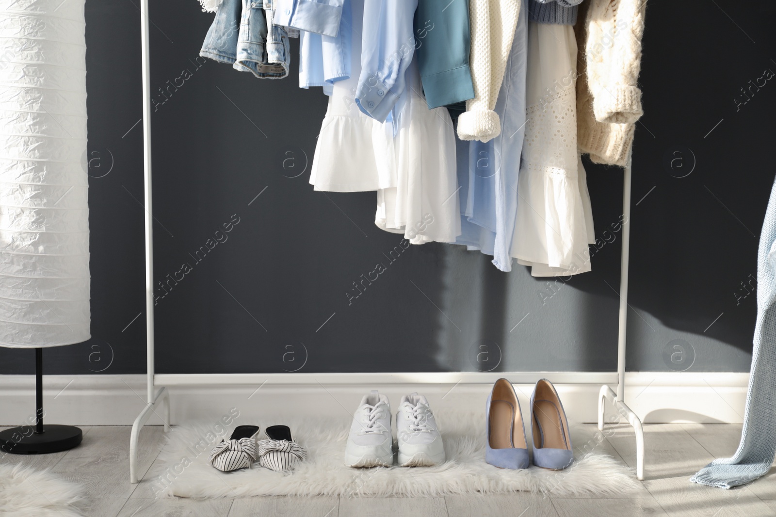 Photo of Rack with stylish women's clothes indoors. Interior design