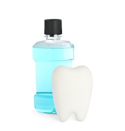 Photo of Tooth shaped holder and mouthwash on white background