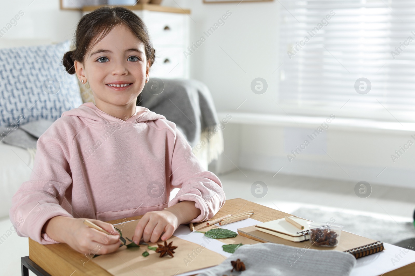 Photo of Little girl working with natural materials at table indoors, space for text. Creative hobby
