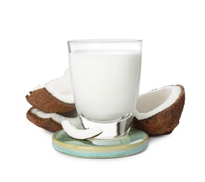 Photo of Glass of delicious coconut milk and coconuts isolated on white