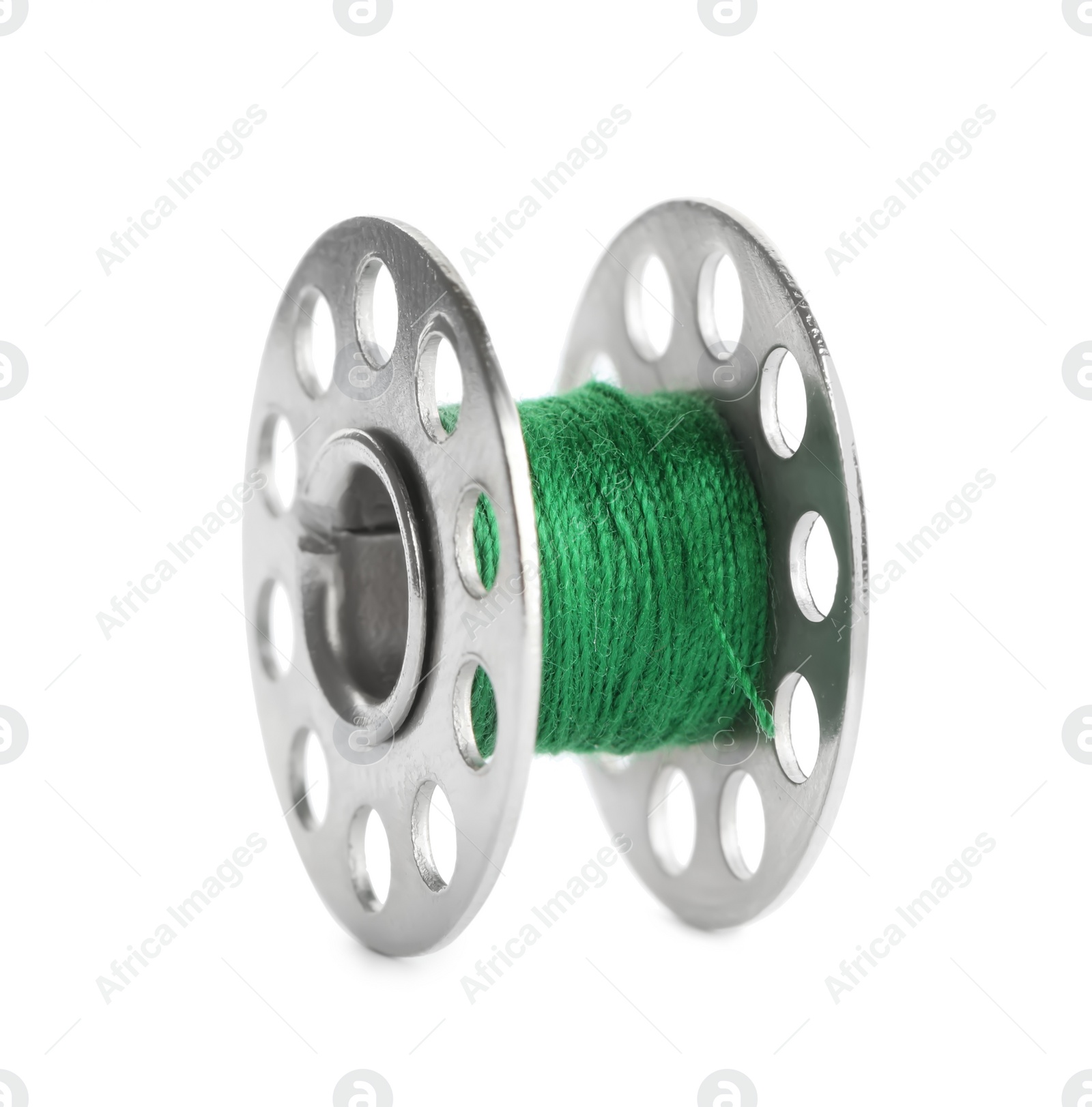 Photo of Metal spool of green sewing thread isolated on white