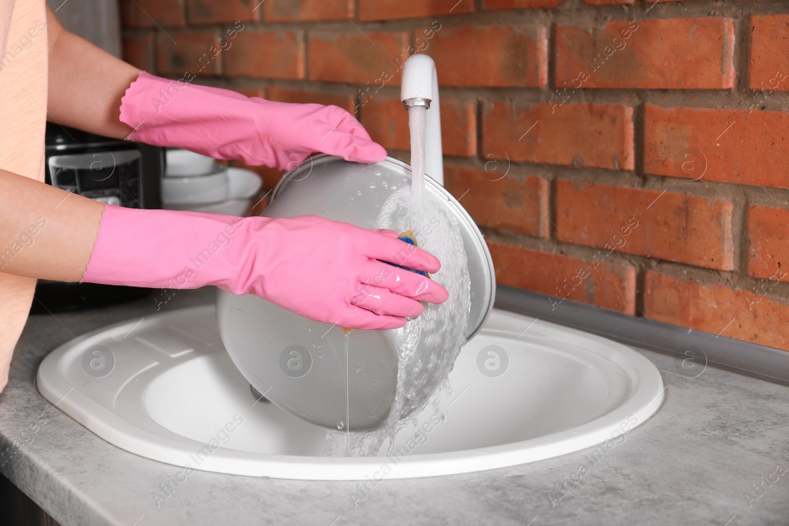 Photo of Woman washing modern multi cooker in kitchen sink, closeup