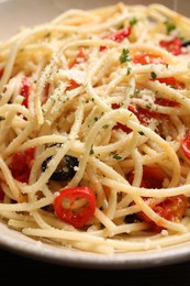 Photo of Delicious pasta with olives, tomatoes and parmesan cheese on table, closeup