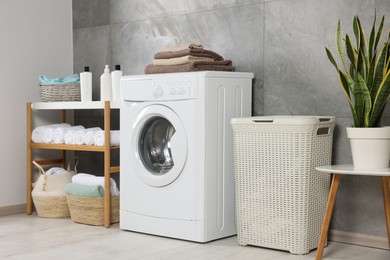 Many soft terry towels and washing machine in bathroom